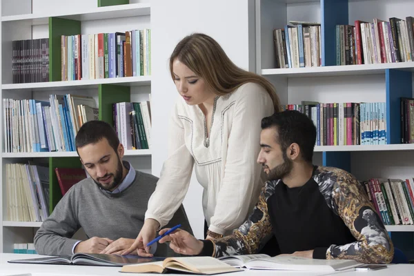Group of students studying at university library — Stock Photo, Image