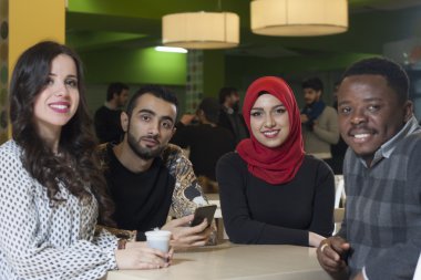 Grup karışık ırk öğrenci kantinde asılı