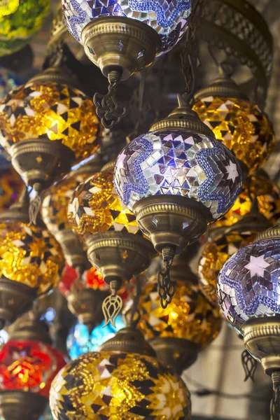 Middle Eastern lambas of different colors and sizes are hanging in the bazaar.