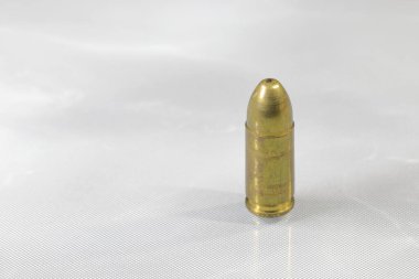 close up bullet 9mm parabellum FMJ (Full Metal Jacket ) on reflection surface.