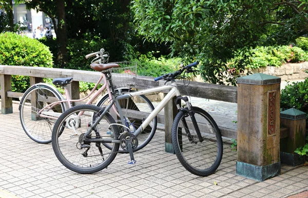 bicycles, The popular transportation type in japan parked on the sidewalk.