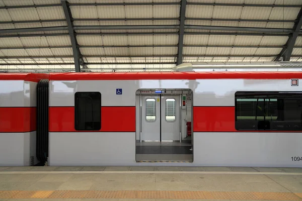 The Red Line Mass Transit System serving the Bangkok Metropolitan Region, Locomotive at platform inside railway station with open door for passengers access.