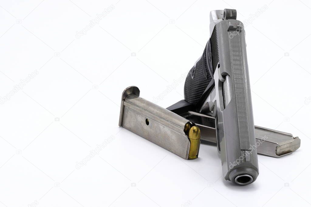 The compact Semi automatic pistol, stainless steel PPKs pistol with spare magazines right side view, Ready for use, lying isolated on white background. 