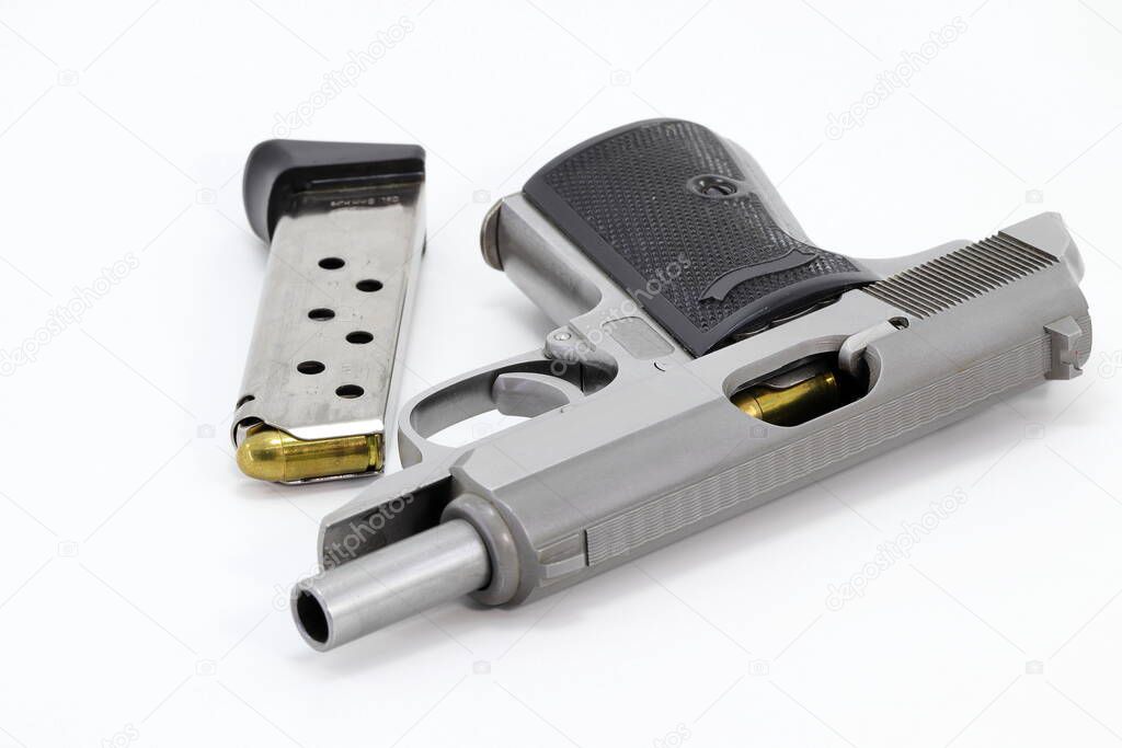 The compact Semi automatic pistol, stainless steel PPKs pistol open slide with spare magazine right side view, Ready for use, lying isolated on white background.