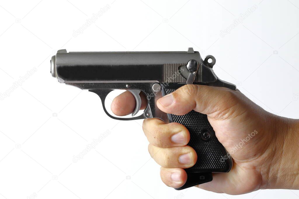 Right Hands holding compact semi automatic gun aiming to target with safety switch on safety position, isolated on on white background.