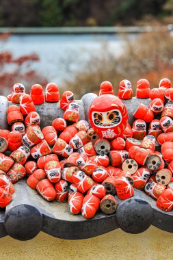 Kararlılığın sembolü, Japoncada iyi şans tılsımı Katsuo-ji tapınağında birçok geleneksel kırmızı Daruma bebeği, Osaka, Japonya.