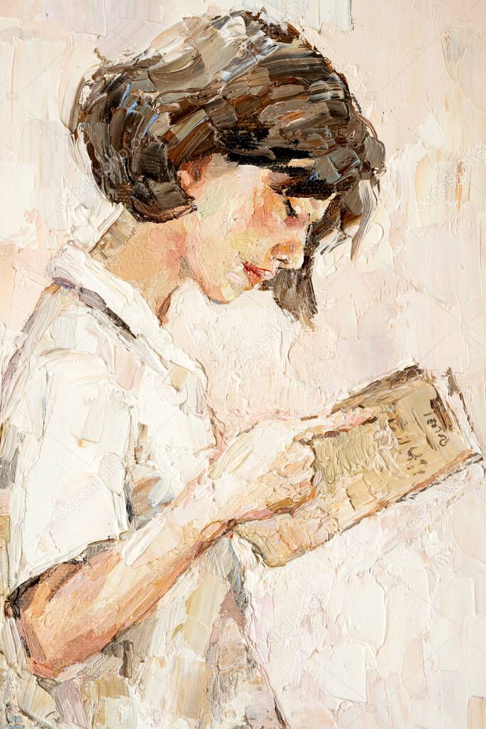.A young girl reads an interesting book on a light warm background. 