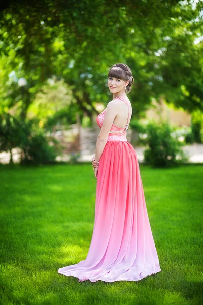 Beautiful young girl in a pink romantic dress Stock Picture