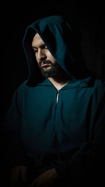 A photo portrait for a African Muslim man praying with a traditional arab blue Djellaba.