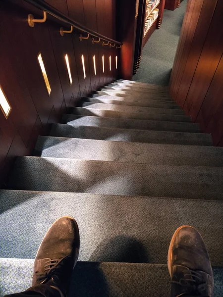 Bu fotoğrafta deri ayakkabılar giyen ve merdivenlerden aşağı inen birini görebilirsiniz.