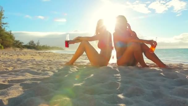 Beautiful Attractive Young Women in Bikinis Sitting on the Beach — Stock Video
