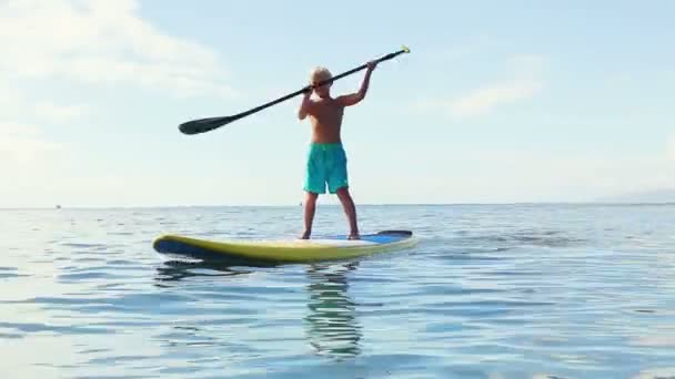 Unga blonda surfare pojke Stand Up Paddling. — Stockvideo