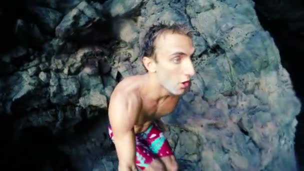 Slow Motion GOPRO POV Young Man Cliff Jump Into Ocean. Selfie Stick — Stock Video