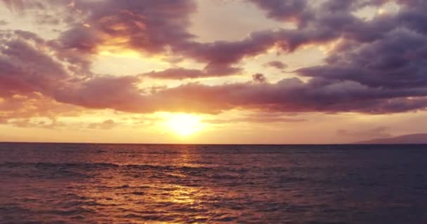 Sunset into Ocean. Aerial View Flying Low over Ocean into Dramatic Vibrant Sunset. — Stock Video