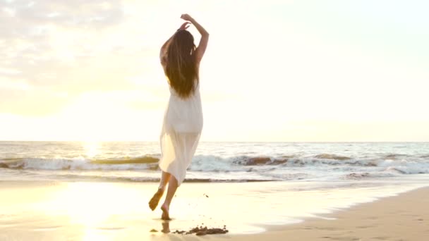 Счастливая девушка, развлекающаяся на пляже на роскошном острове на закате. Slow Motion — стоковое видео