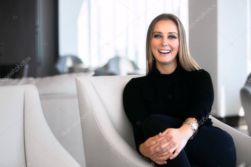 Business portrait of a beautiful and successful executive CEO or entrepreneur in a modern office, smiling, confident, classy