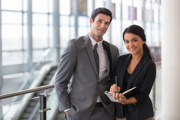 Business executive e assistente che viaggiano alla convention durante un viaggio in aeroporto prendendo appunti ritratto — Foto Stock