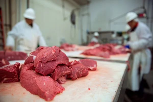 Stacked pile of red raw meat uncooked being cut and butchered — Stock Photo, Image