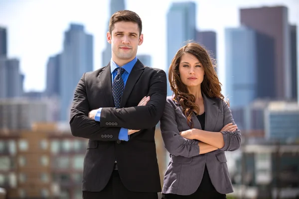 Pretty woman and handsome businessman posing with serious expression determined for success — Stock fotografie
