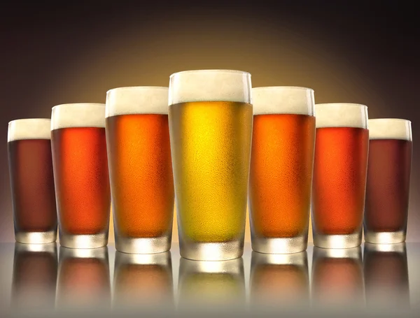 A tasty delicious row of a variety craft brew tap beers in pub glasses on reflective surface — Stock Photo, Image