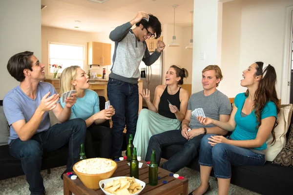 Poker player winner rejoices celebrates victory in front of group of people victorious