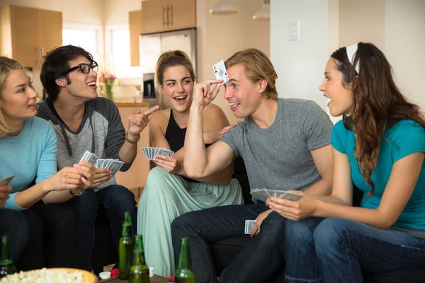 Funny poker player game night group of friends at home laughing — Stock Photo, Image