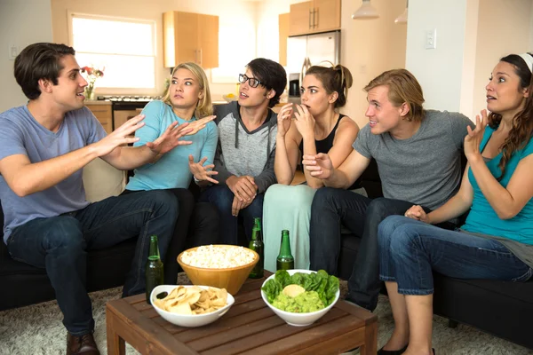 Large group of friends at a party get together house drinking beer chatting storytelling gossiping — Stock Photo, Image