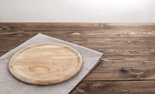 Background for product montage. Round wooden board with tablecloth.