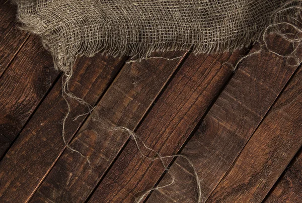 Textura de yute viejo sobre fondo de mesa de madera — Foto de Stock