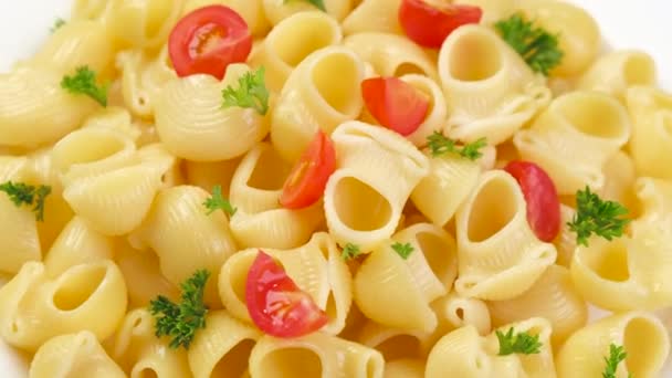 Pipa italiana amañar pasta con tomates y hojas de albahaca — Vídeos de Stock
