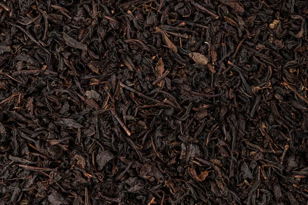 Hojas de té seco fondo o textura, patrón de té negro — Foto de Stock