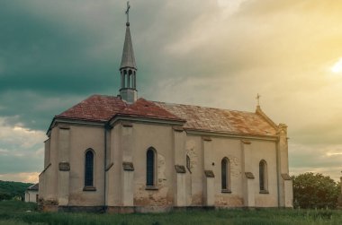 19. yüzyılın eski kilisesi Ukrayna 'daki köydeki günbatımı kilisesinde kara bulutların arka planında