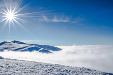 Güneşli dağlarda kar ve sis 