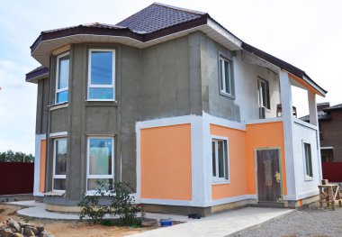 Close up on Painting and Plastering Exterior House Wall. Facade Thermal Insulation and Painting Work clipart