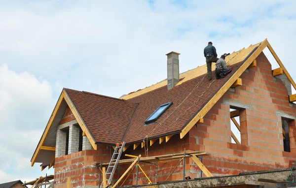 Dakdekkers- en dakbedekking bouw- en gebouw nieuw baksteen huis met modulaire schoorsteen, dakramen, zolder, leisteen en Eaves. — Stockfoto