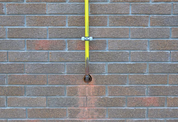 Closeup on Gas Pipe System Connection Installed in House Wall. Make Gas Line Connections From Steel or Copper Pipes to Ranges, Clothes Dryers Safe and Secure by Using  Proper Fittings, Connections.