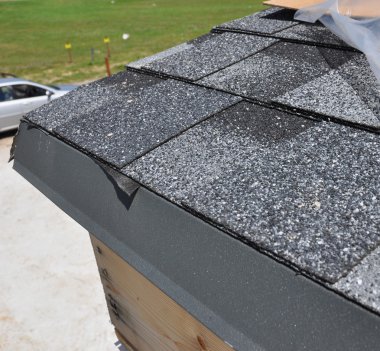 Closeup of waterproof problem roofing. Placement of asphalt shingles. Roof repair.