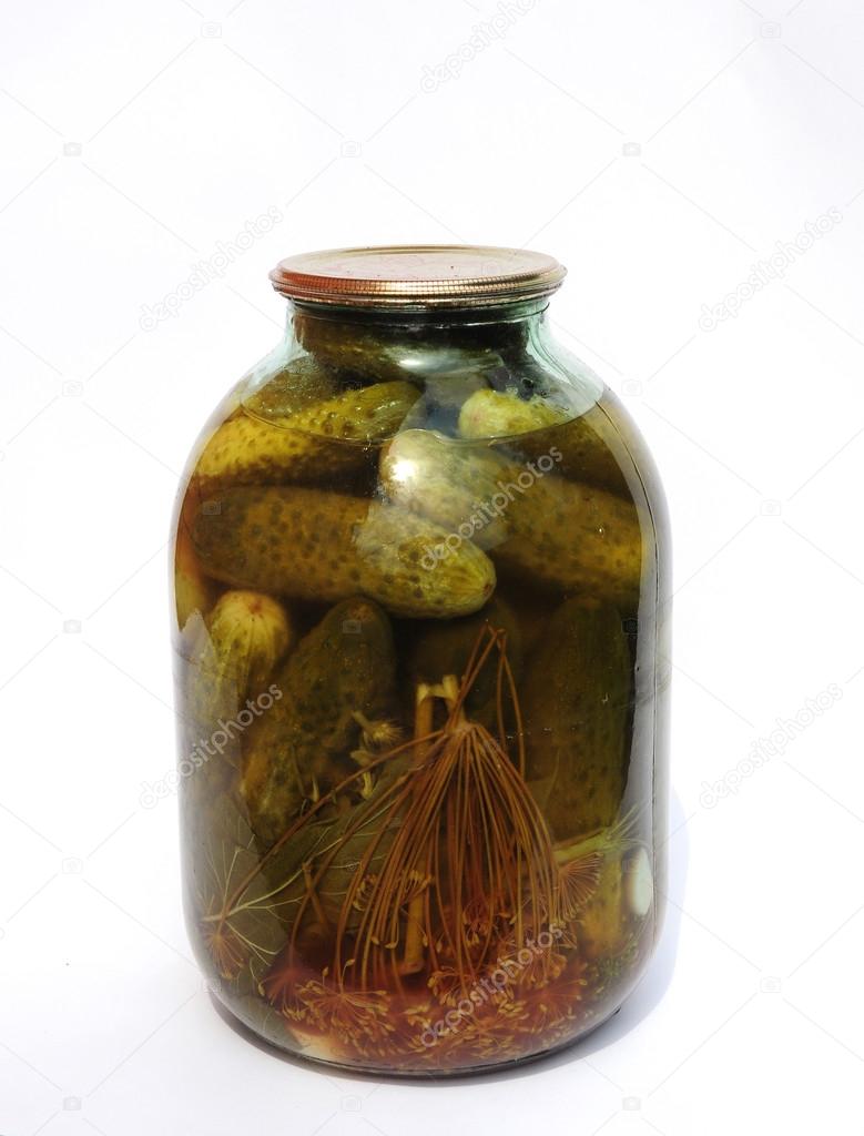 Jar of canned cucumbers, dill, garlic, pepper isolated on white