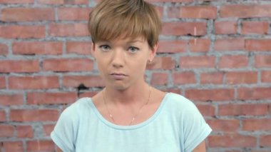 Genç kız tasvir üzüntü, o zaman zevk, mutlu kamera. Döküm. Tuğla duvar