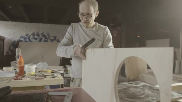 Professional woodworker connects two wooden polished board. Furniture. Hammer — Stock Video