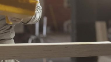 Woodworker paint varnish long wooden board by brush, roller. Manufacturer