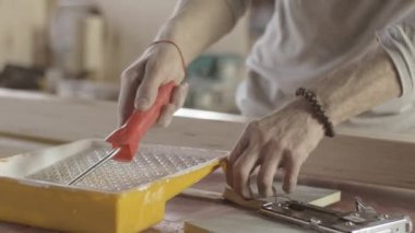 Woodworker dye varnish long wooden board by production roller. Manufacturer