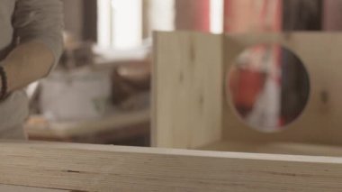 Woodworker process surface of wooden board by belt sander. Smoothing