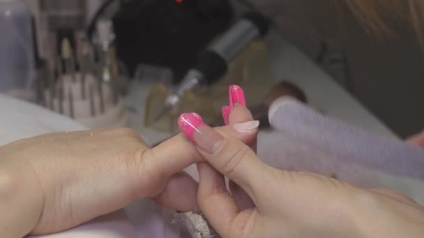 Pregos mestre lidar com unhas de cliente por nailfile no salão de beleza. Correção de forma. Pó de sopro — Vídeo de Stock