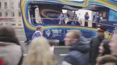 SAINT PETERSBURG, RUSSIA - OCTOBER 27, 2013: Walking man give pompons to people. Relay race Sochi Olympic flame in Saint Petersburg. Olympic bus.