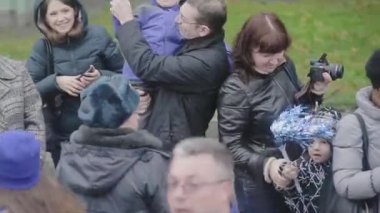 Saint Petersburg, Rusya - 27 Ekim 2013: Kalabalık insan, küçük çocuklar dalga kırmızı mavi ponpon, gülümseme. Otobüsle giden kamera. Sonbahar