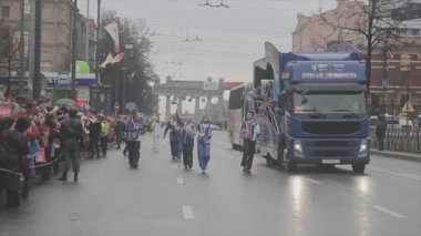 SAINT PETERSBURG, RUSSIA - OCTOBER 27, 2013: Cortege from bus walk volunteers wave pom pom. Relay race of Sochi Olympic flame in Saint Petersburg