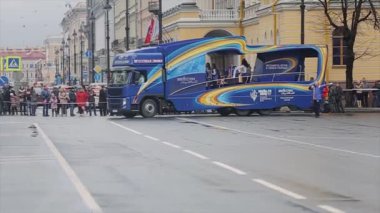 SAINT PETERSBURG, RUSSIA - OCTOBER 27, 2013: Volunteers bus with dancing young people. Relay race of Sochi Olympic flame in Saint Petersburg