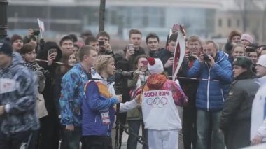 SAINT PETERSBURG, RUSSIA - OCTOBER 27, 2013: Relay race Olympic flame in Saint Petersburg in October. Young torchbearer after run give interview