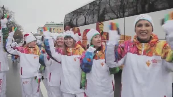 SAN PETERSBURG, RUSIA - 27 DE OCTUBRE DE 2013: Carrera de relevos Sochi llama olímpica en San Petersburgo. Los portadores de antorchas transfieren fuego. Mano de saludo. Voluntario — Vídeo de stock